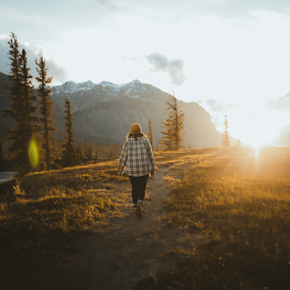 person talking a hike in mountains
