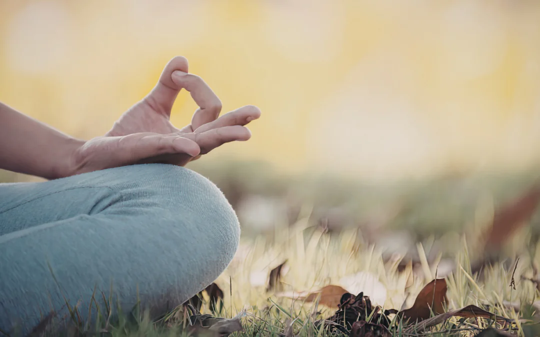 person meditating in field